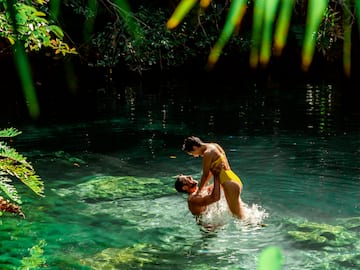 a man and woman in a body of water