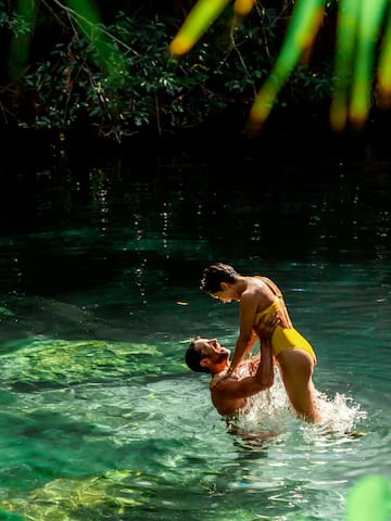 a man and woman in a body of water