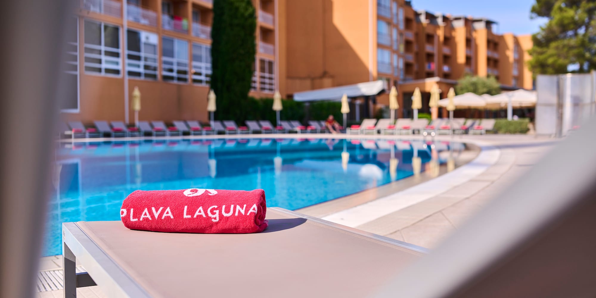 a towel on a lounge chair by a pool
