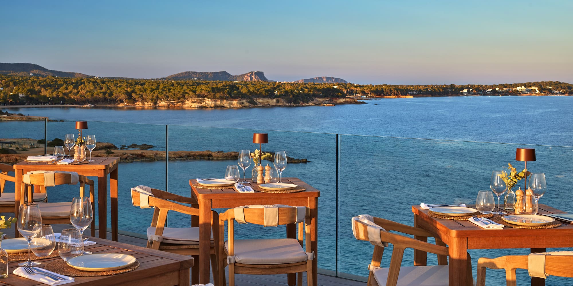 a table and chairs on a deck overlooking a body of water