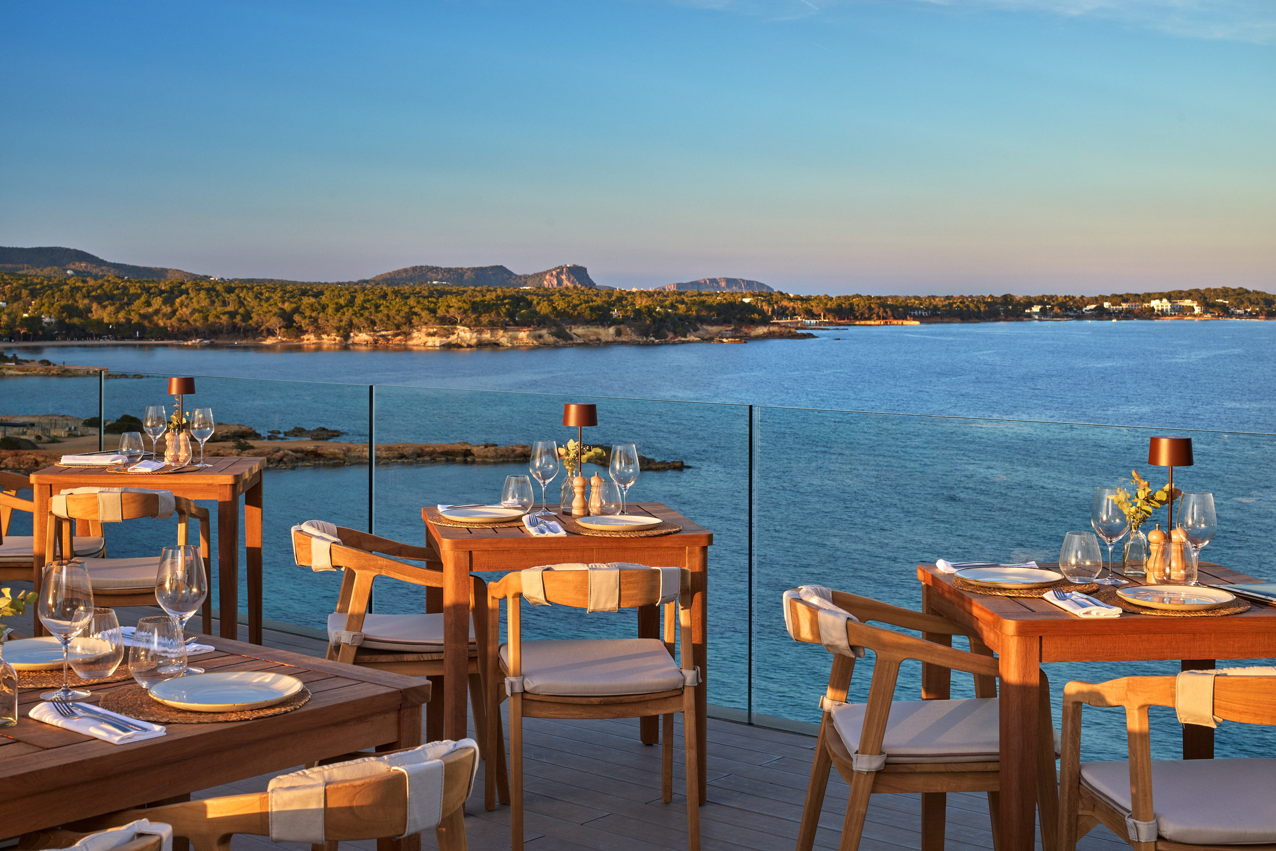 a table and chairs on a deck overlooking a body of water