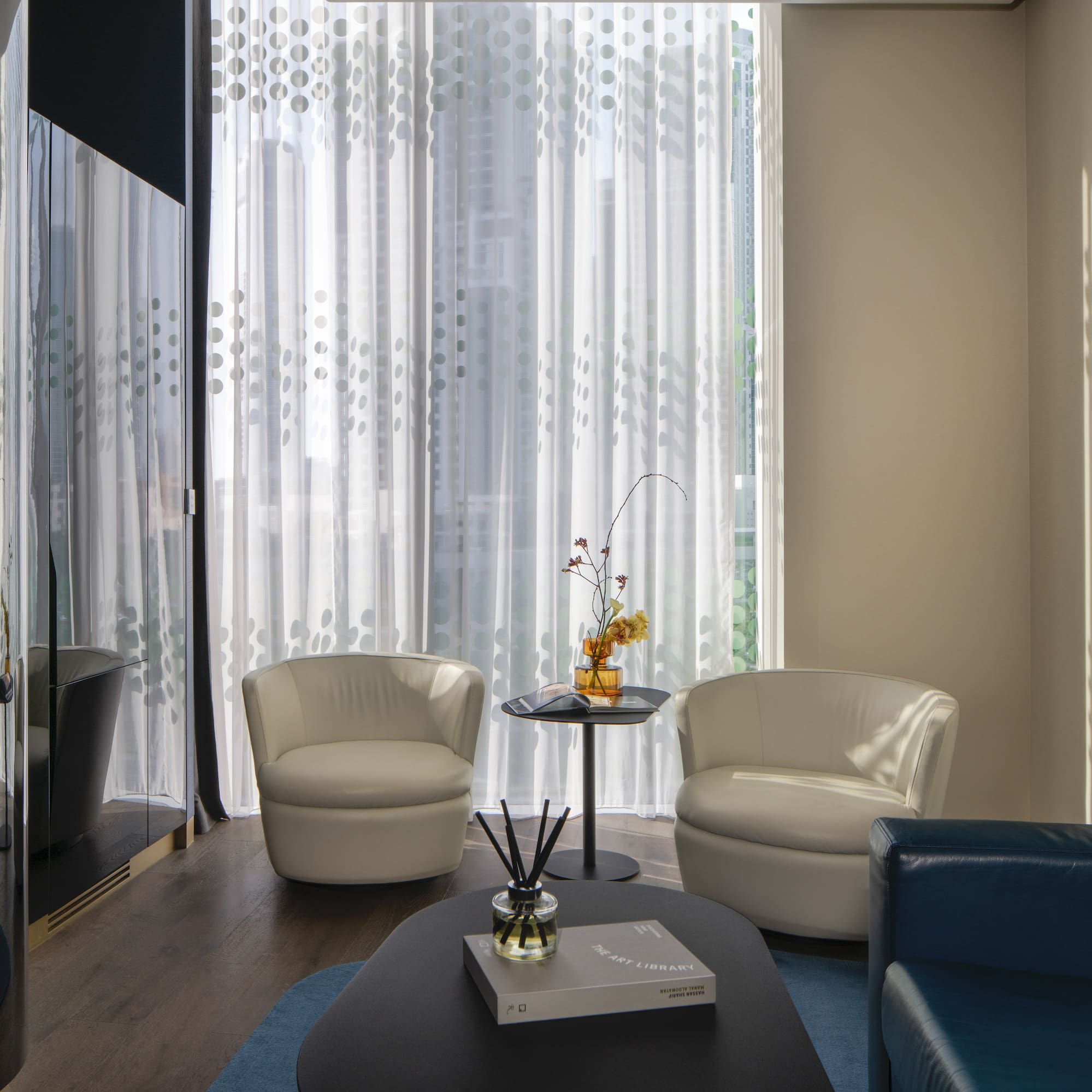 a room with white chairs and a table