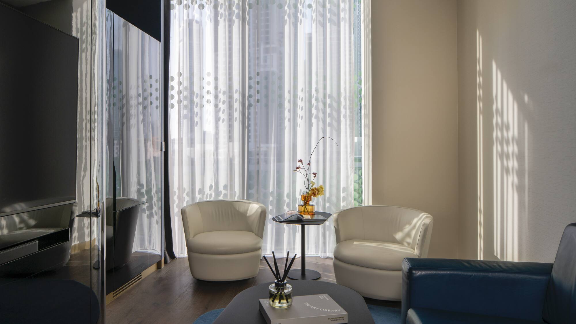 a room with white chairs and a table