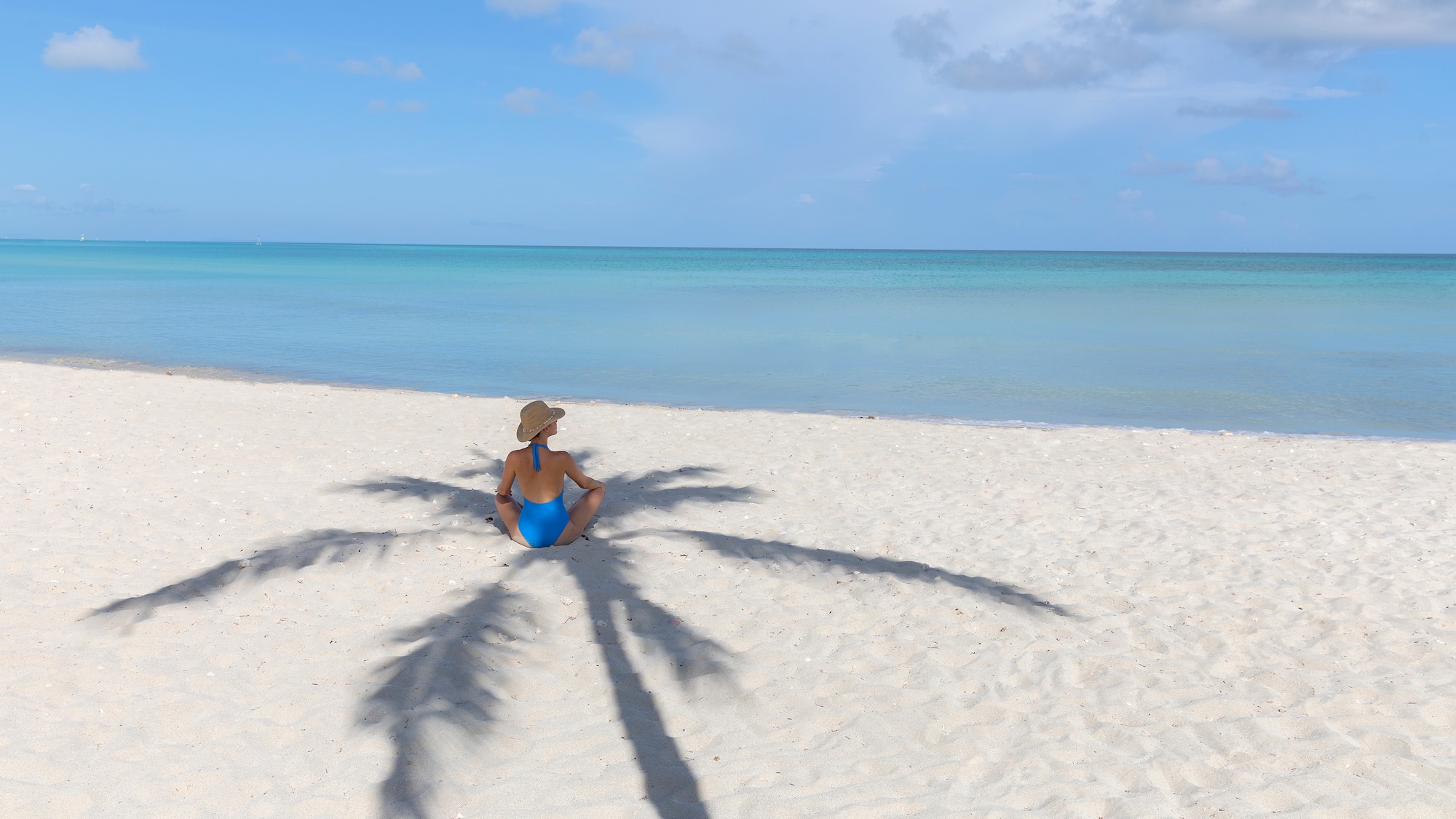 a woman sitting on a beach