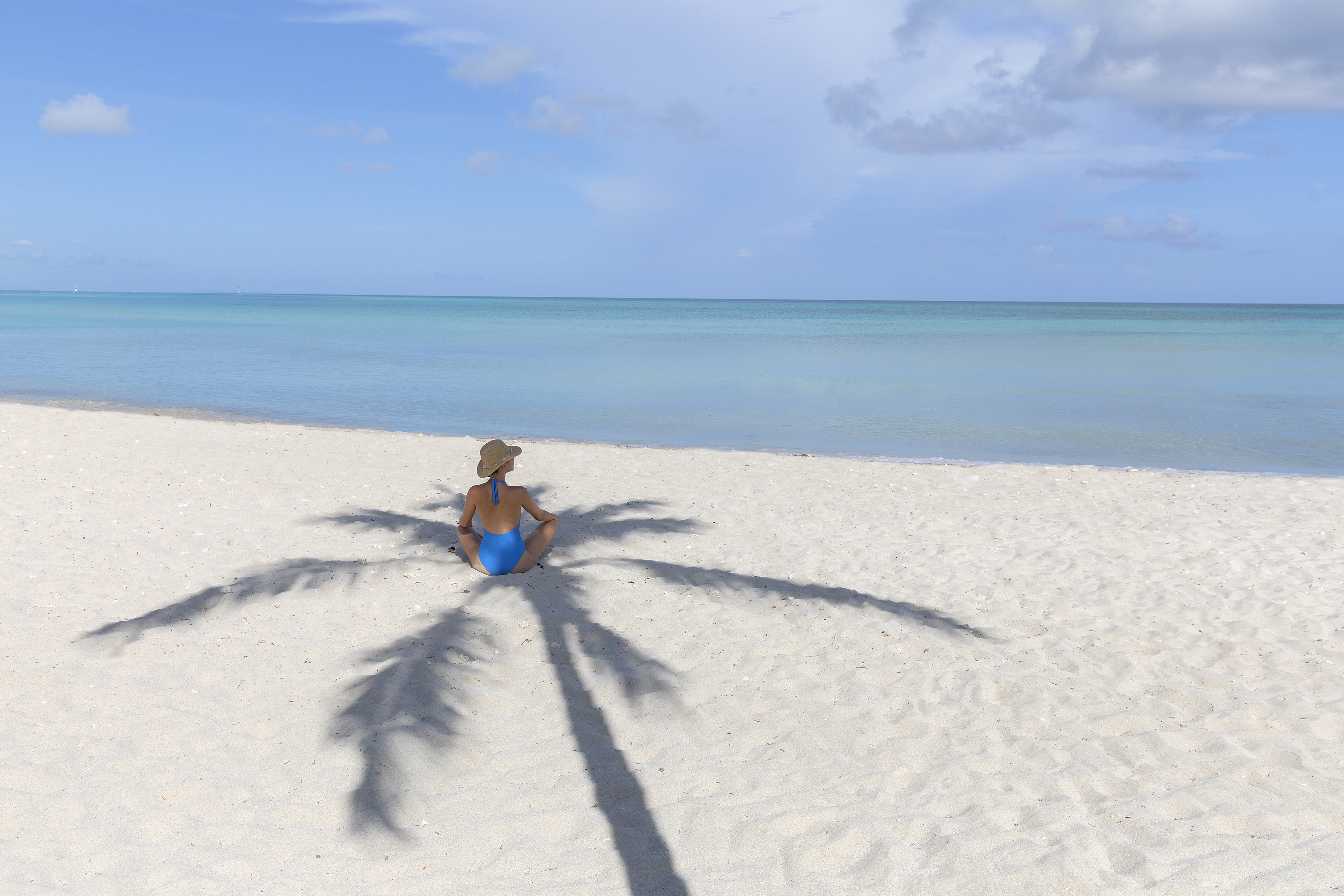 a woman sitting on a beach
