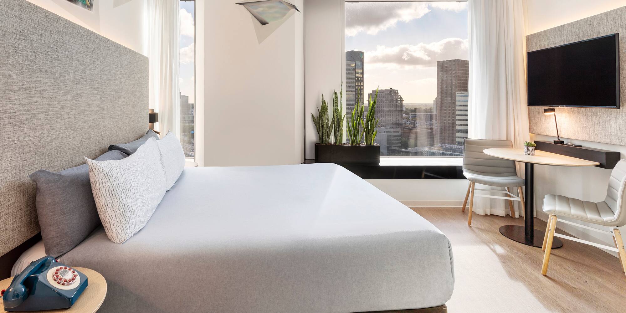 a bedroom with a large bed and a table and chairs