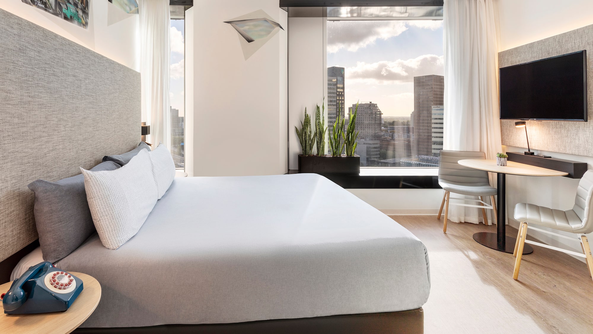 a bedroom with a large bed and a table and chairs