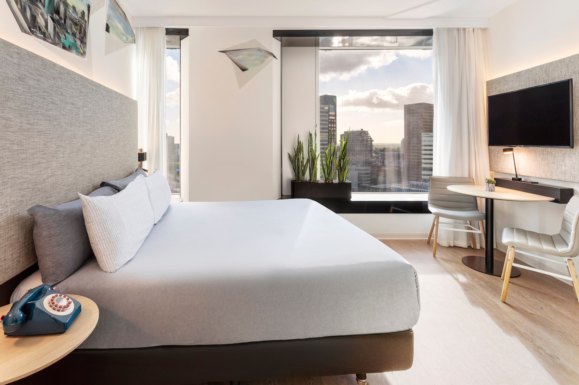 a bedroom with a large bed and a table and chairs