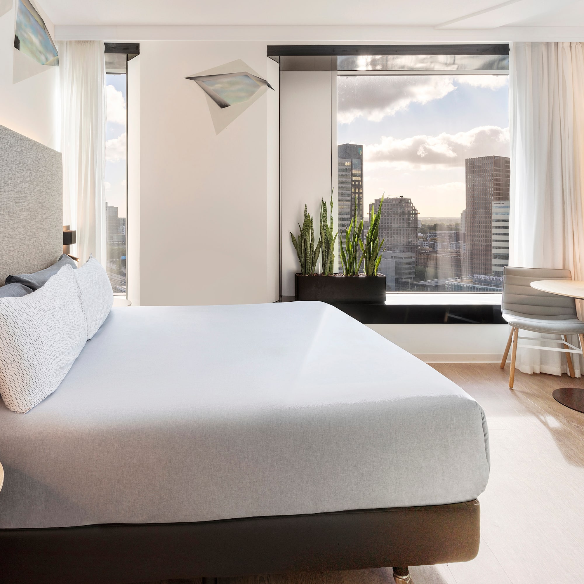 a bedroom with a large bed and a table and chairs