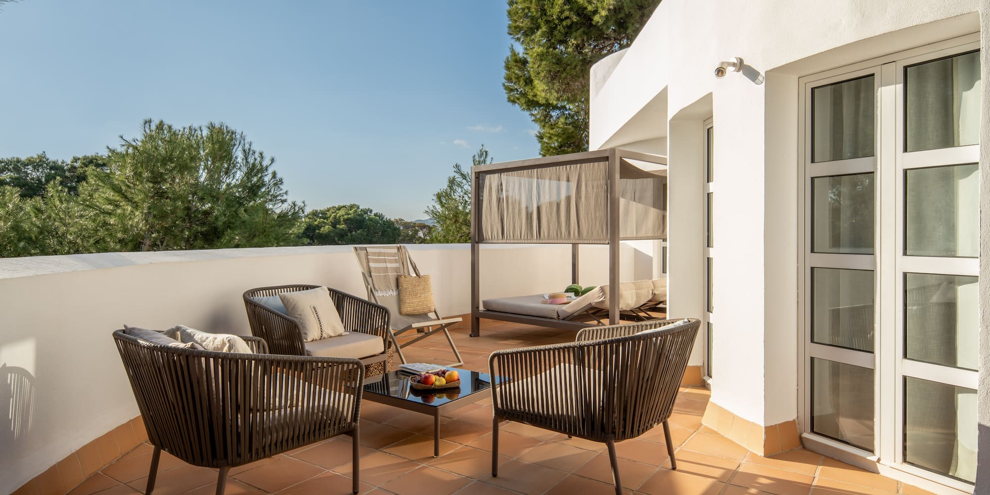 a patio with chairs and a table