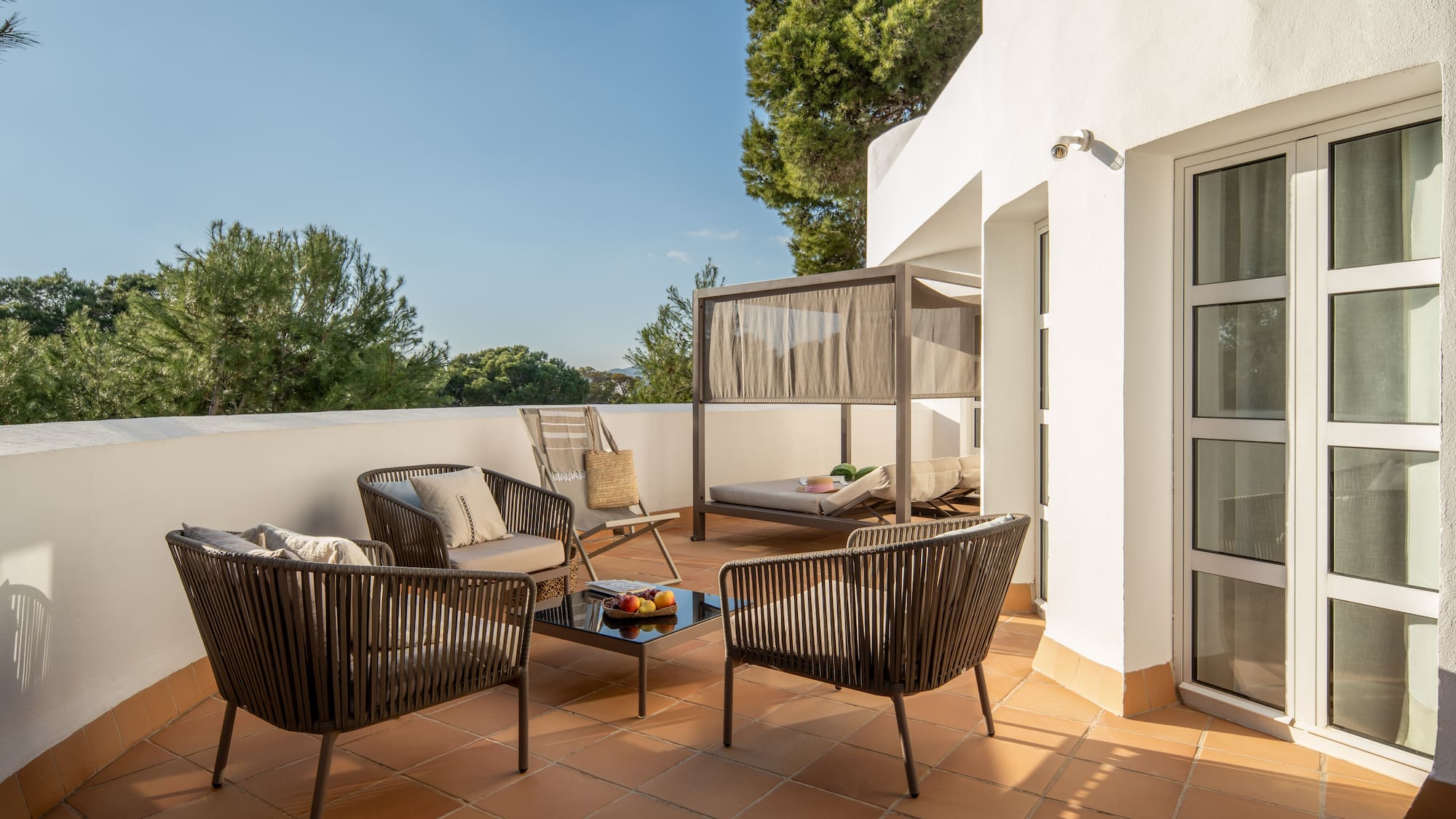 a patio with chairs and a table
