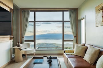 a living room with a view of a lake and mountains