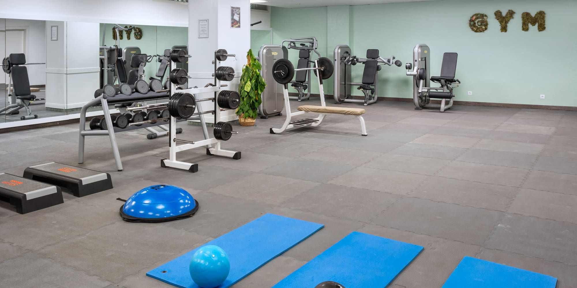 a gym with exercise equipment and exercise balls