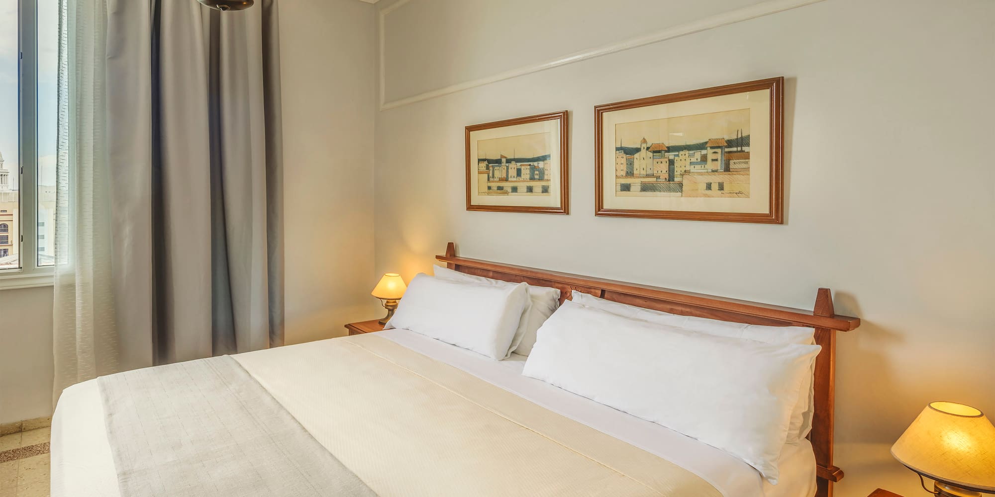 a bed with a wood headboard and a lamp