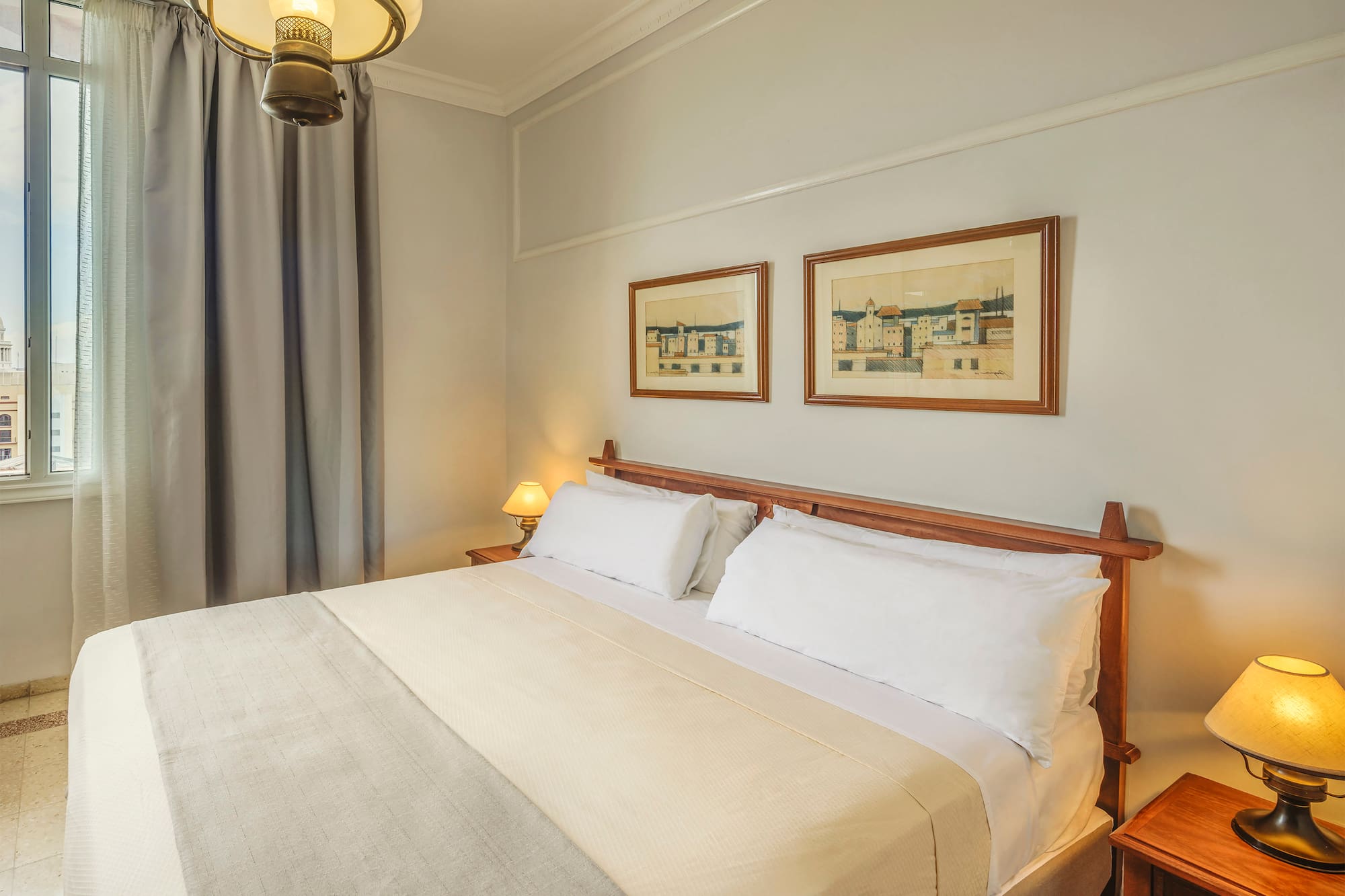 a bed with a wood headboard and a lamp