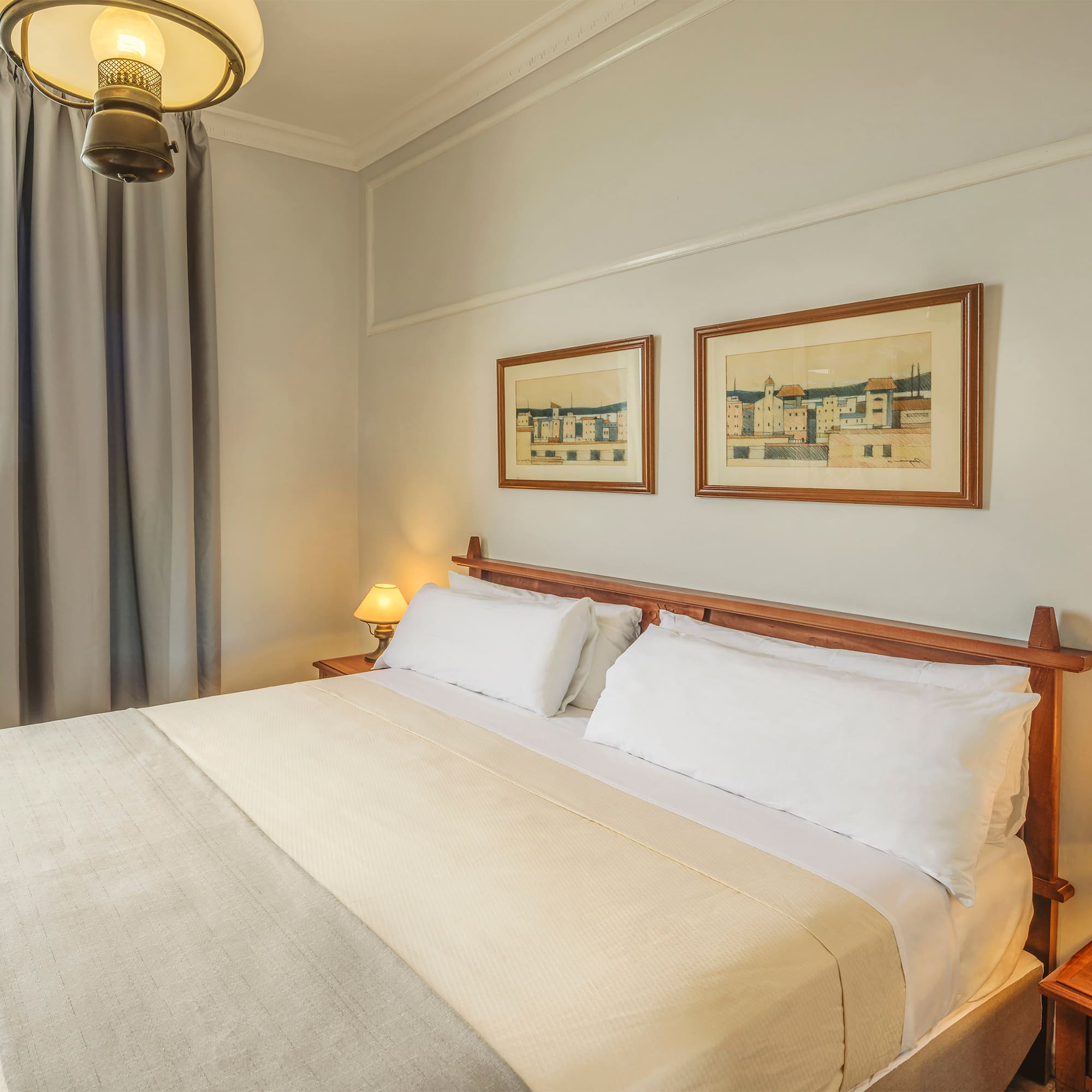 a bed with a wood headboard and a lamp