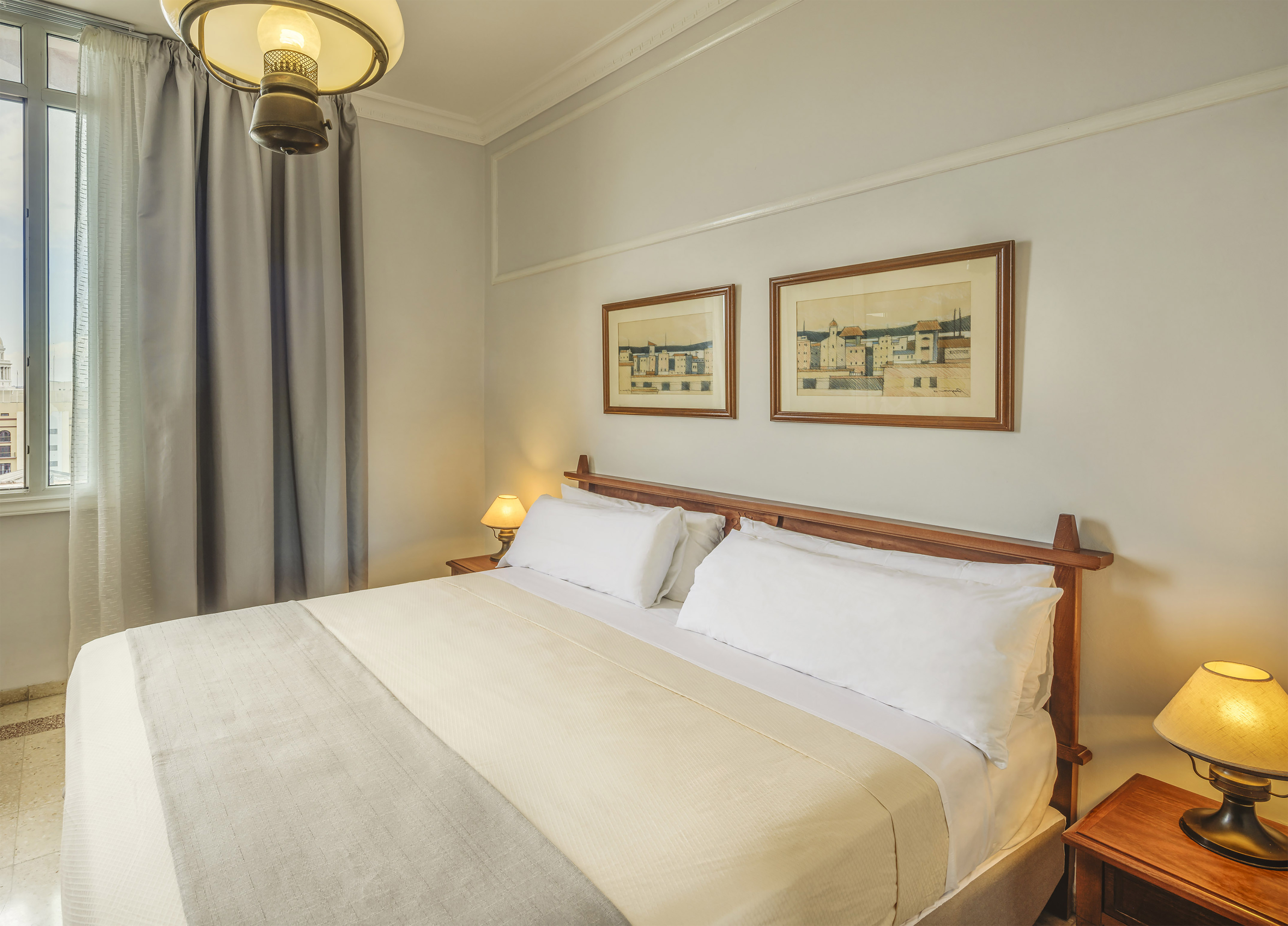 a bed with a wood headboard and a lamp