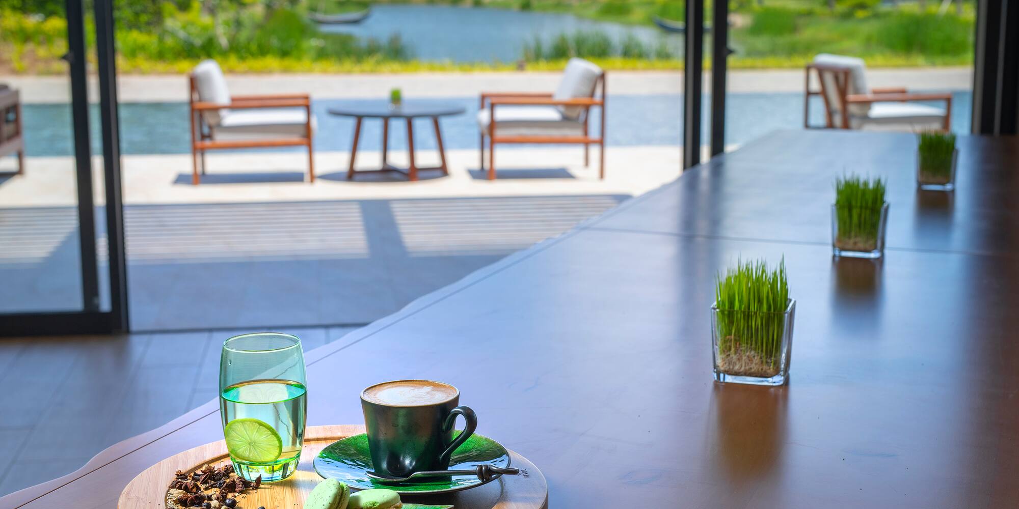 a table with a cup of coffee and a glass of water