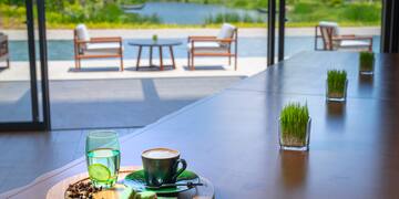 a table with a cup of coffee and a glass of water