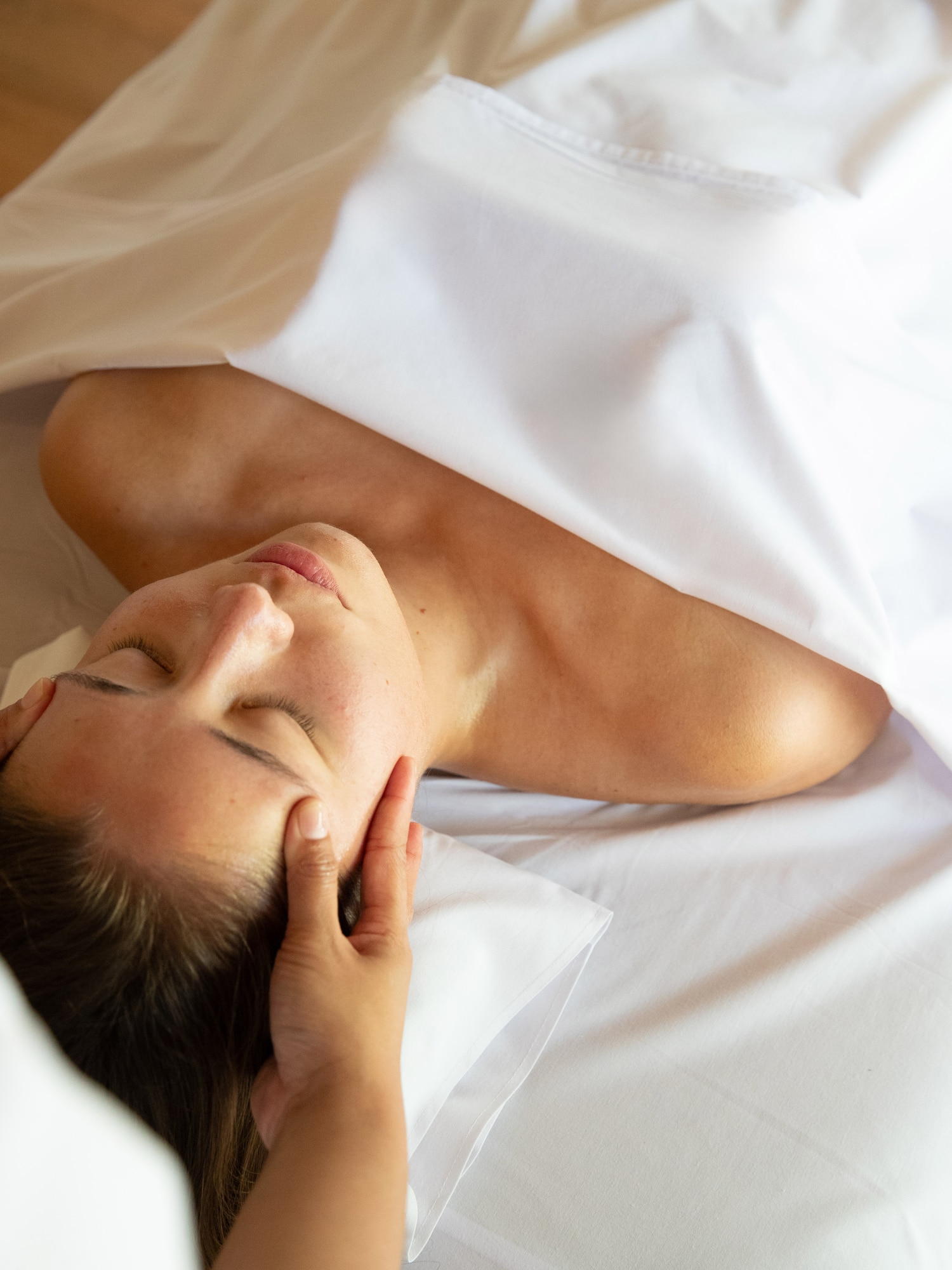a woman lying down with her eyes closed