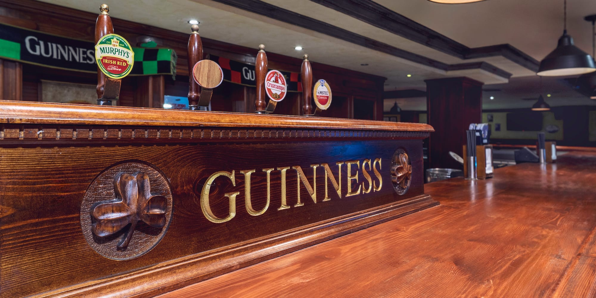 a wooden bar with beer taps