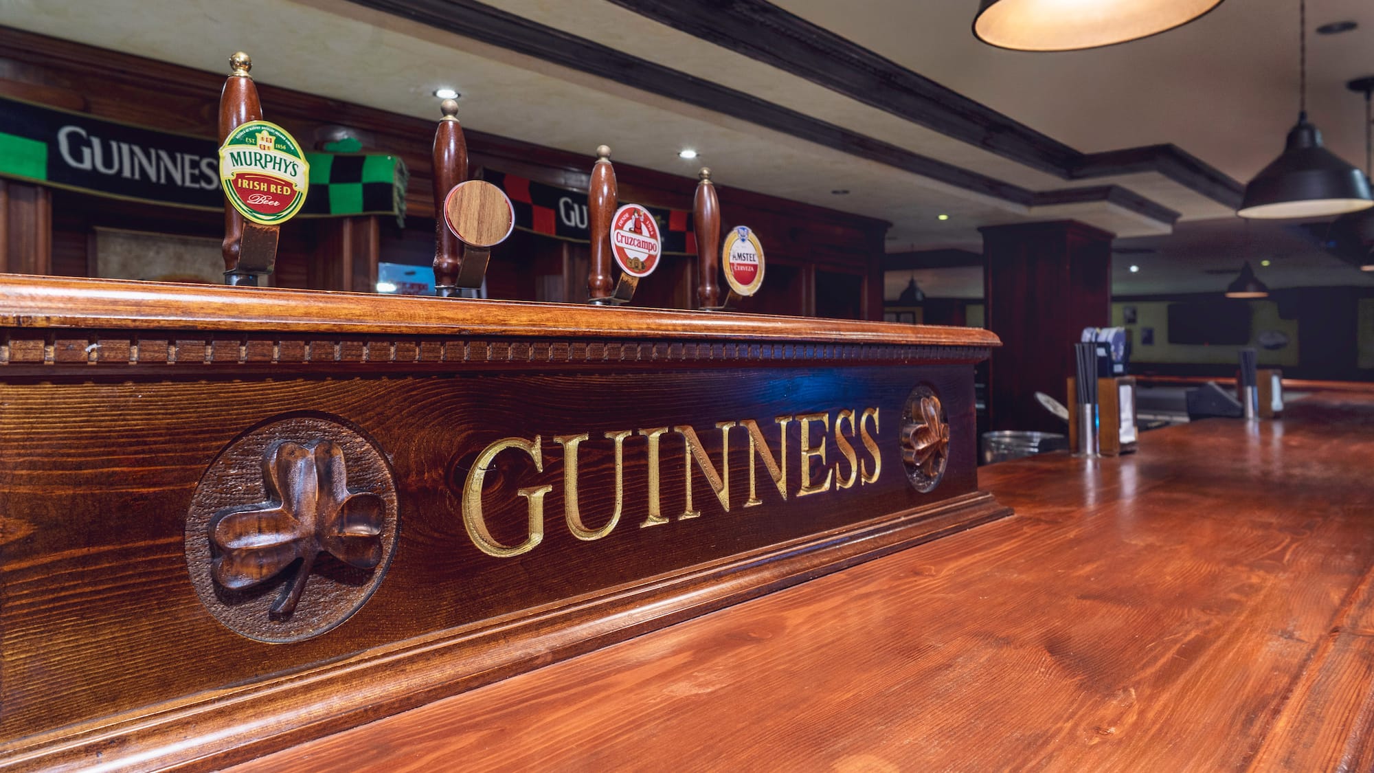a wooden bar with beer taps