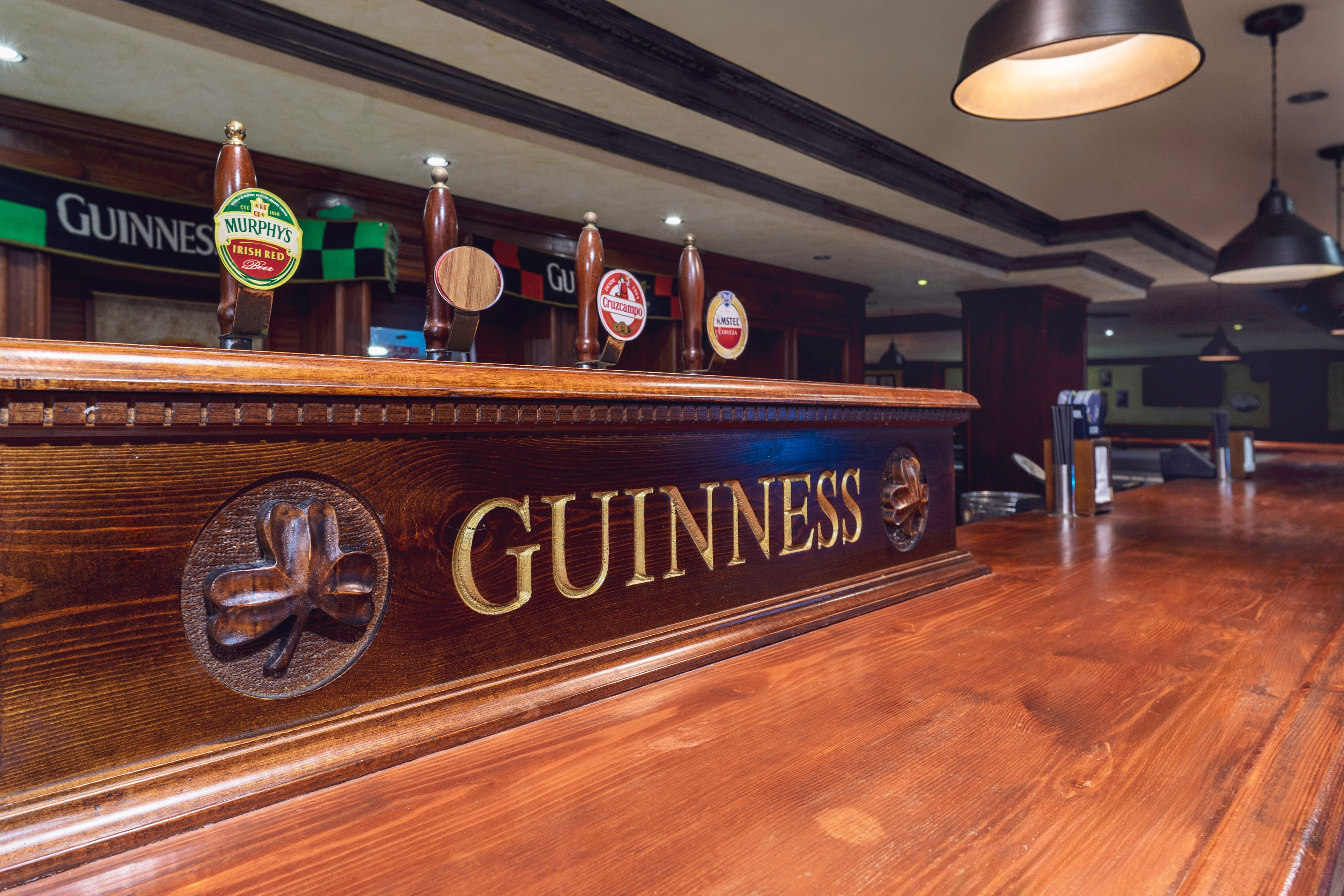 a wooden bar with beer taps