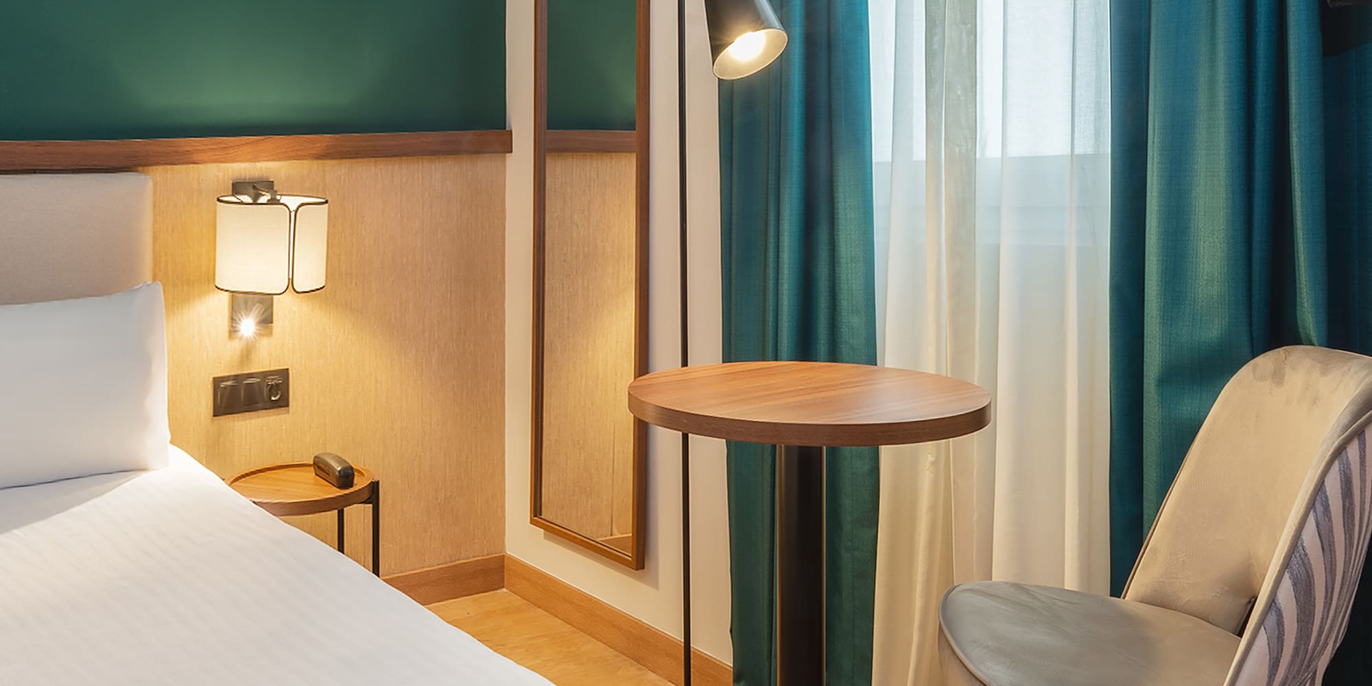 a room with a bed and a table and chair