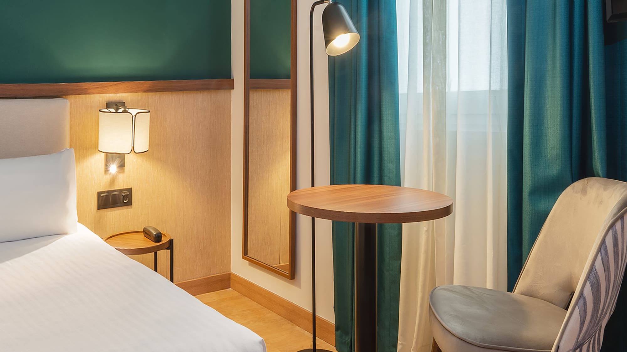 a room with a bed and a table and chair