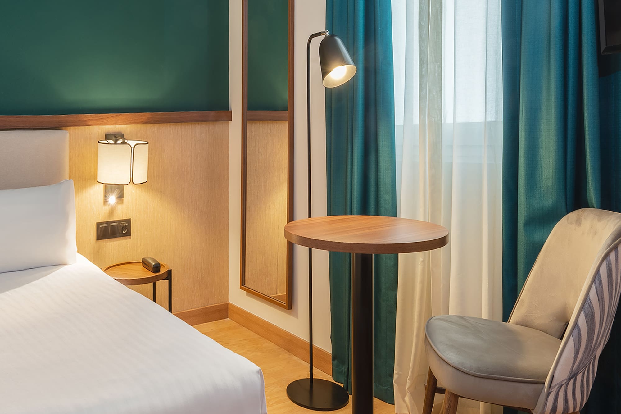 a room with a bed and a table and chair