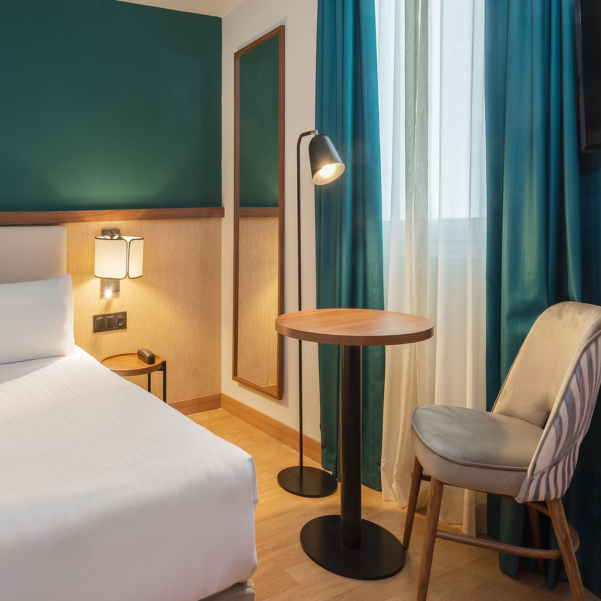 a room with a bed and a table and chair