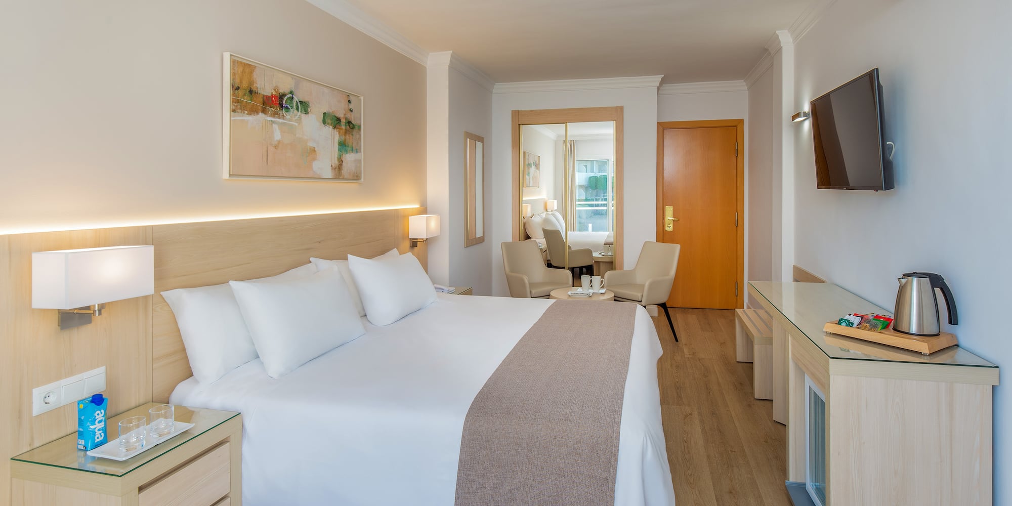 a bedroom with a bed and a television