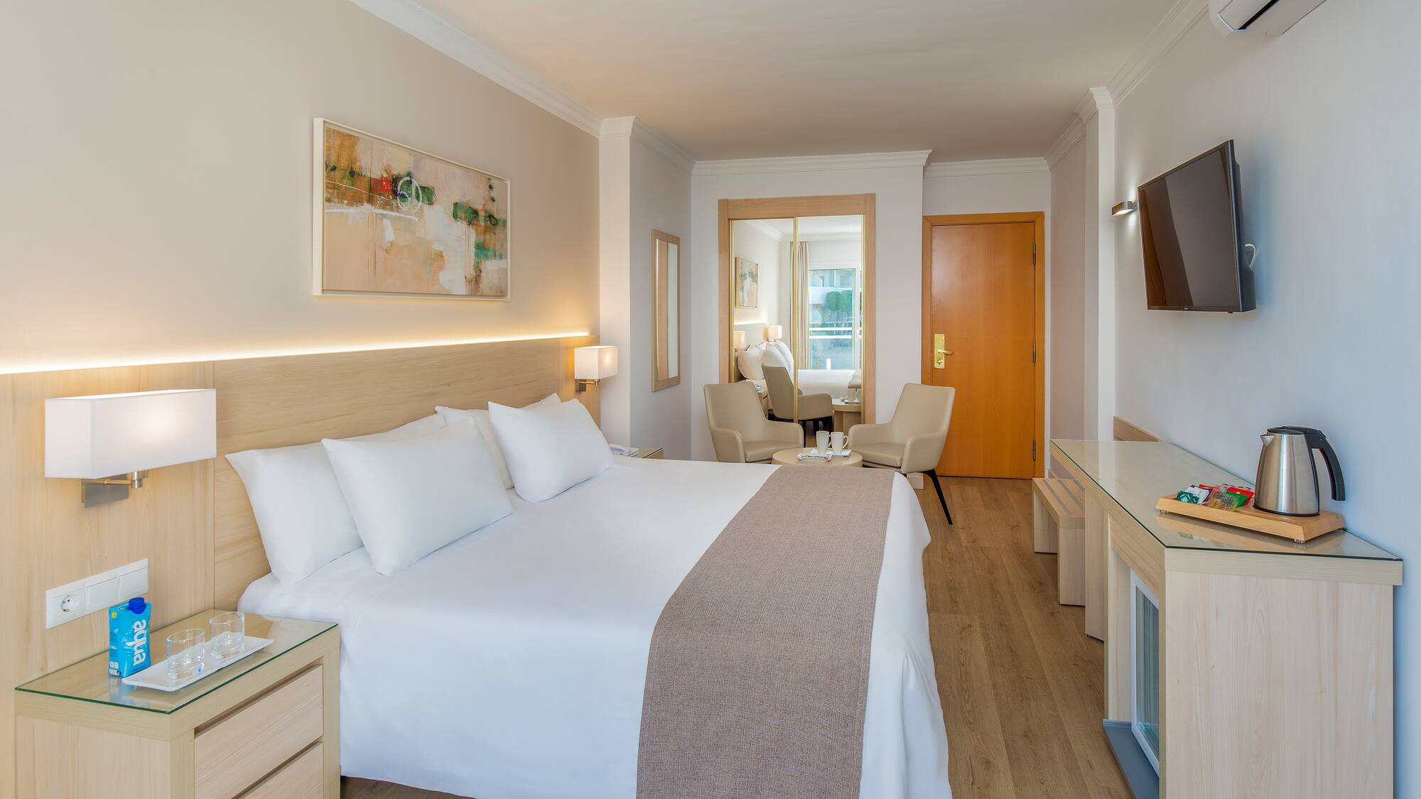 a bedroom with a bed and a television