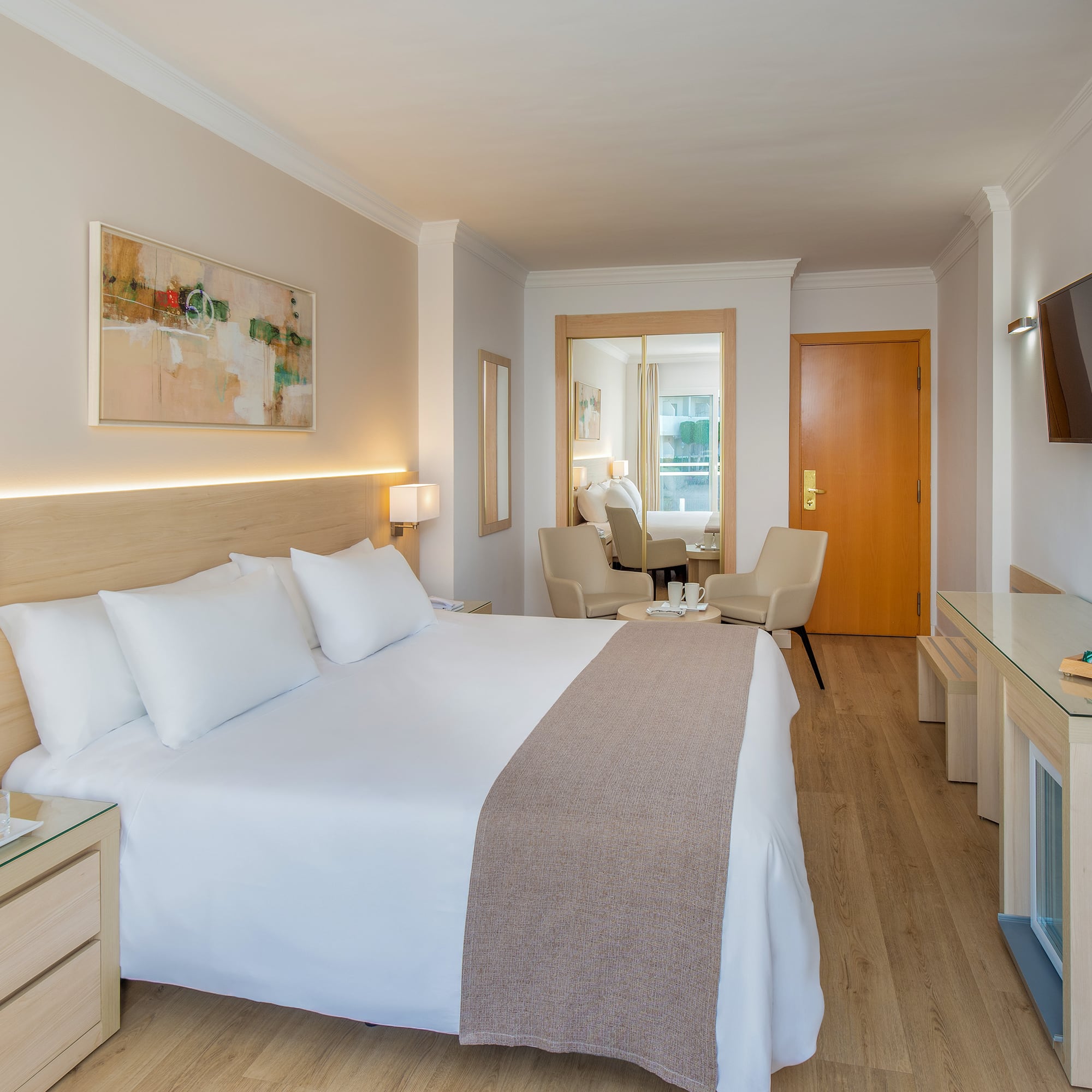 a bedroom with a bed and a television