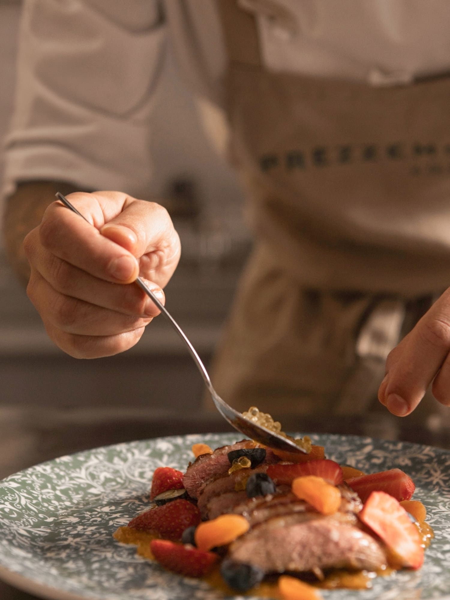a person holding a fork over a plate of food