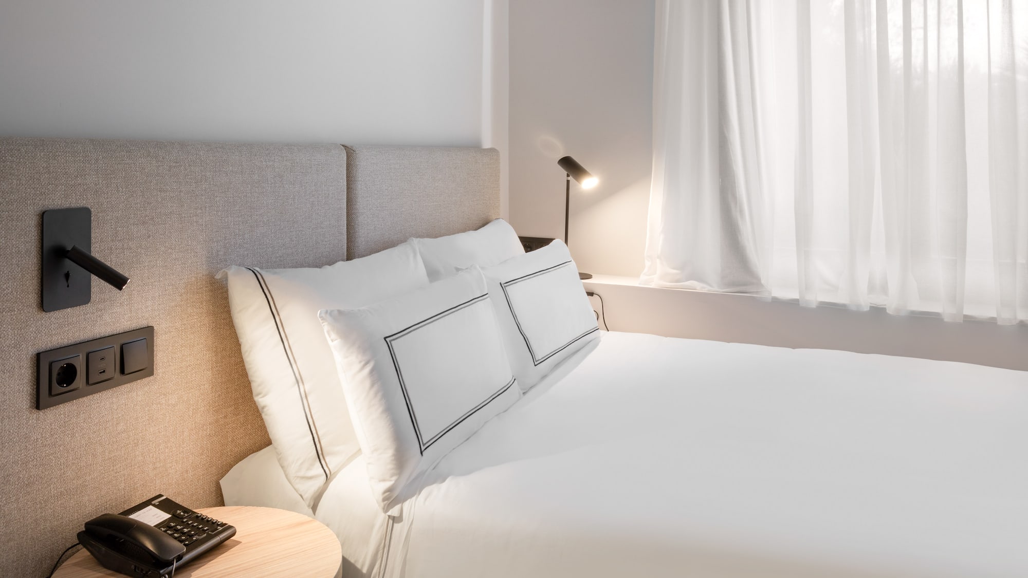 a bed with a lamp and a table