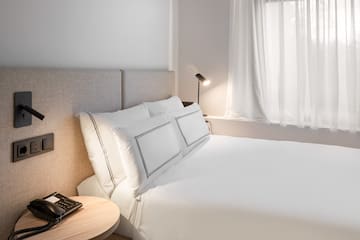 a bed with a lamp and a table