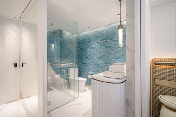 a bathroom with a blue wall and a toilet