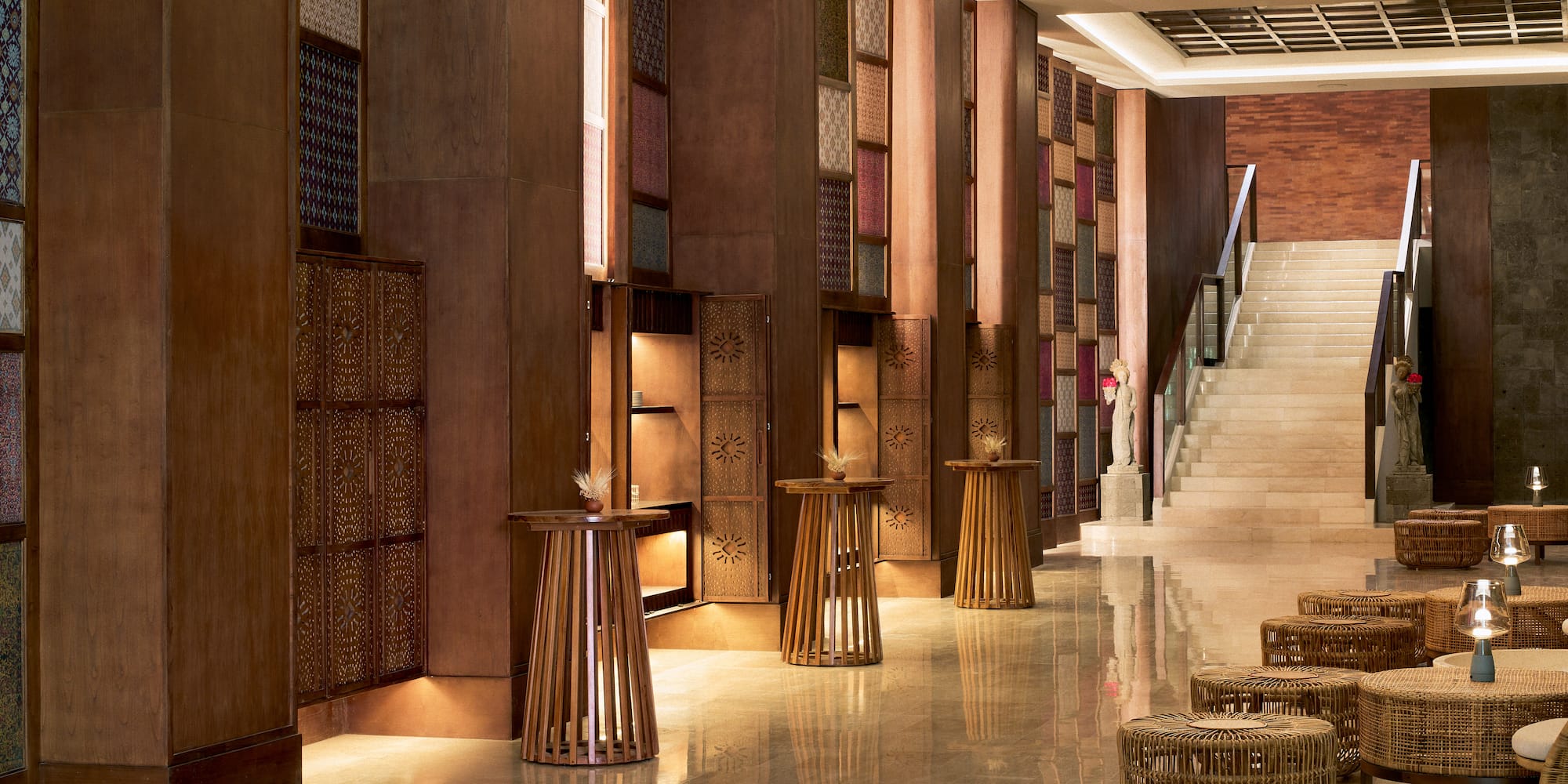 a hallway with a staircase and tables