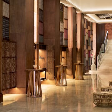 a hallway with a staircase and tables