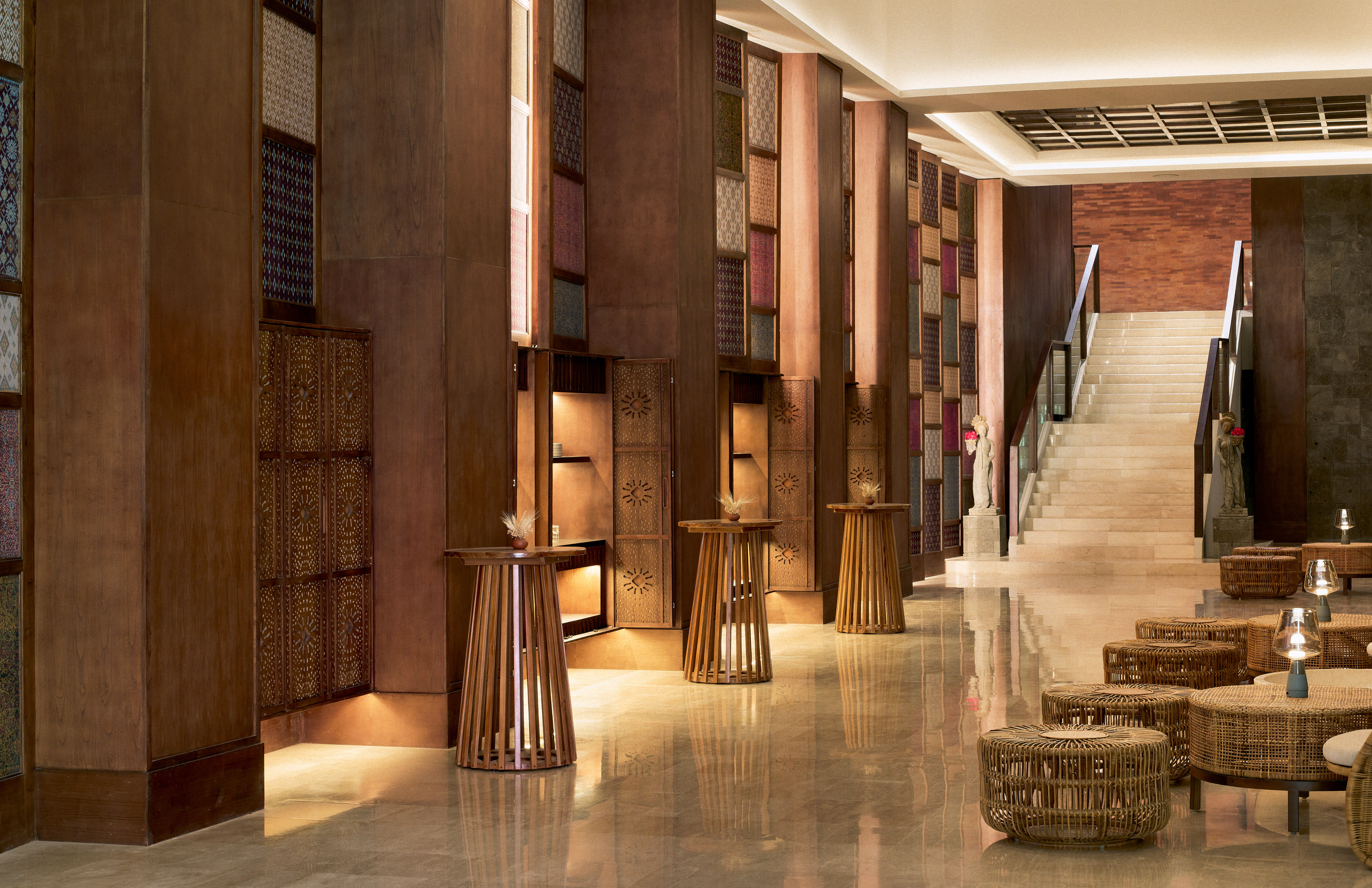 a hallway with a staircase and tables
