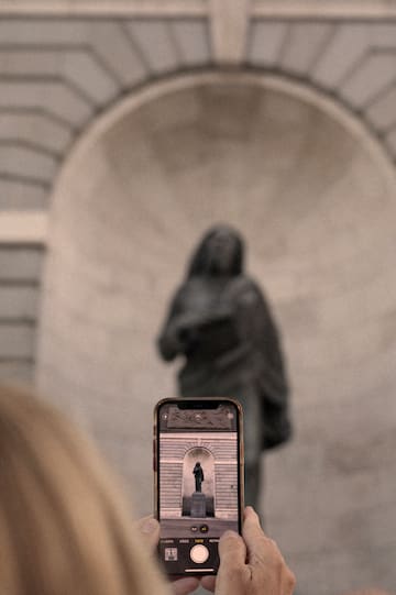 a phone with a keyhole in front of a statue