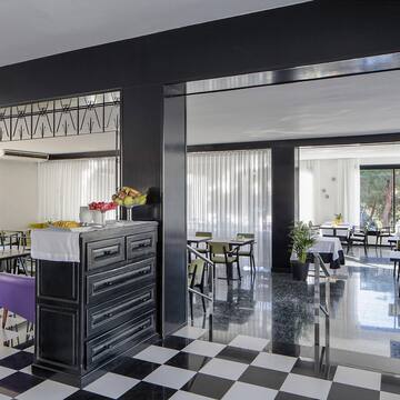a room with black and white checkered flooring and tables