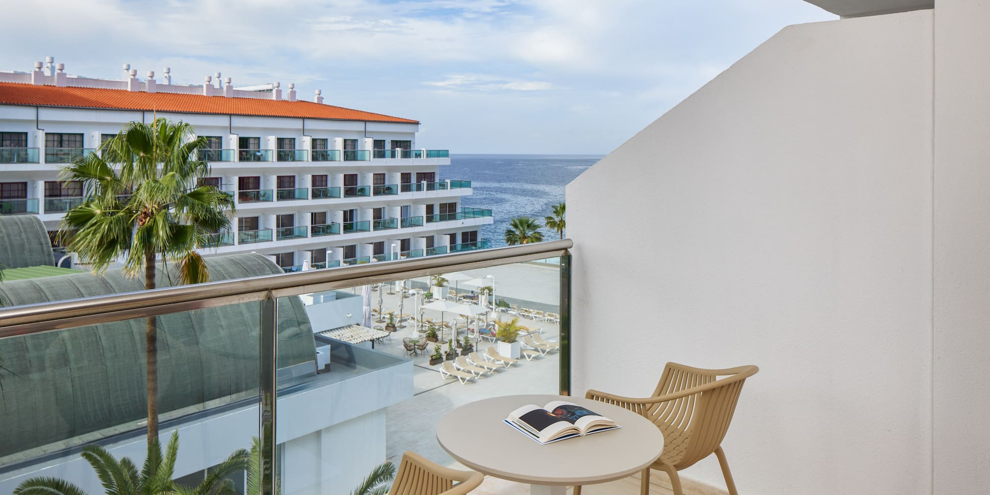 a balcony with chairs and a book