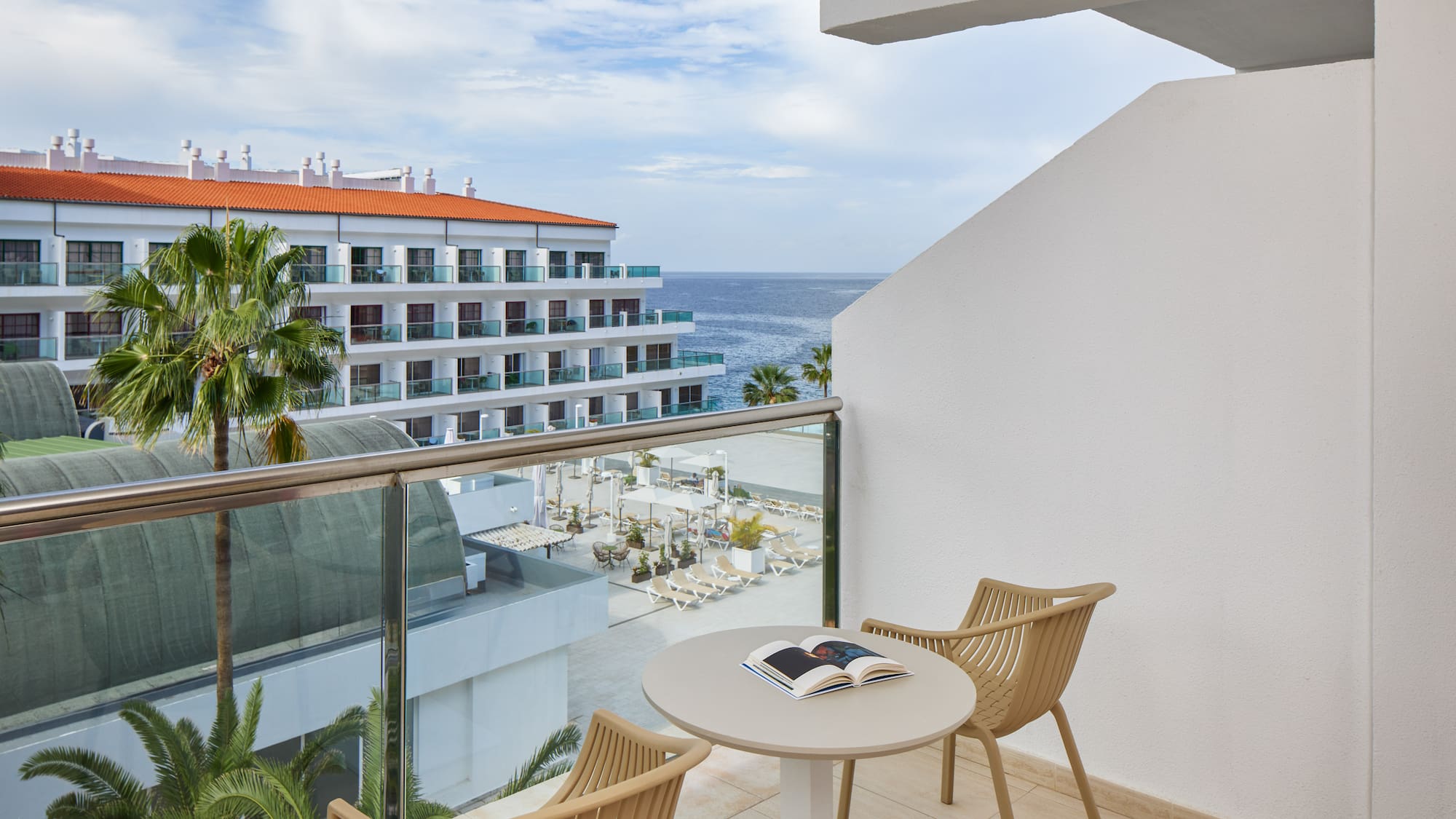 a balcony with chairs and a book