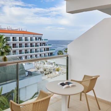 a balcony with chairs and a book