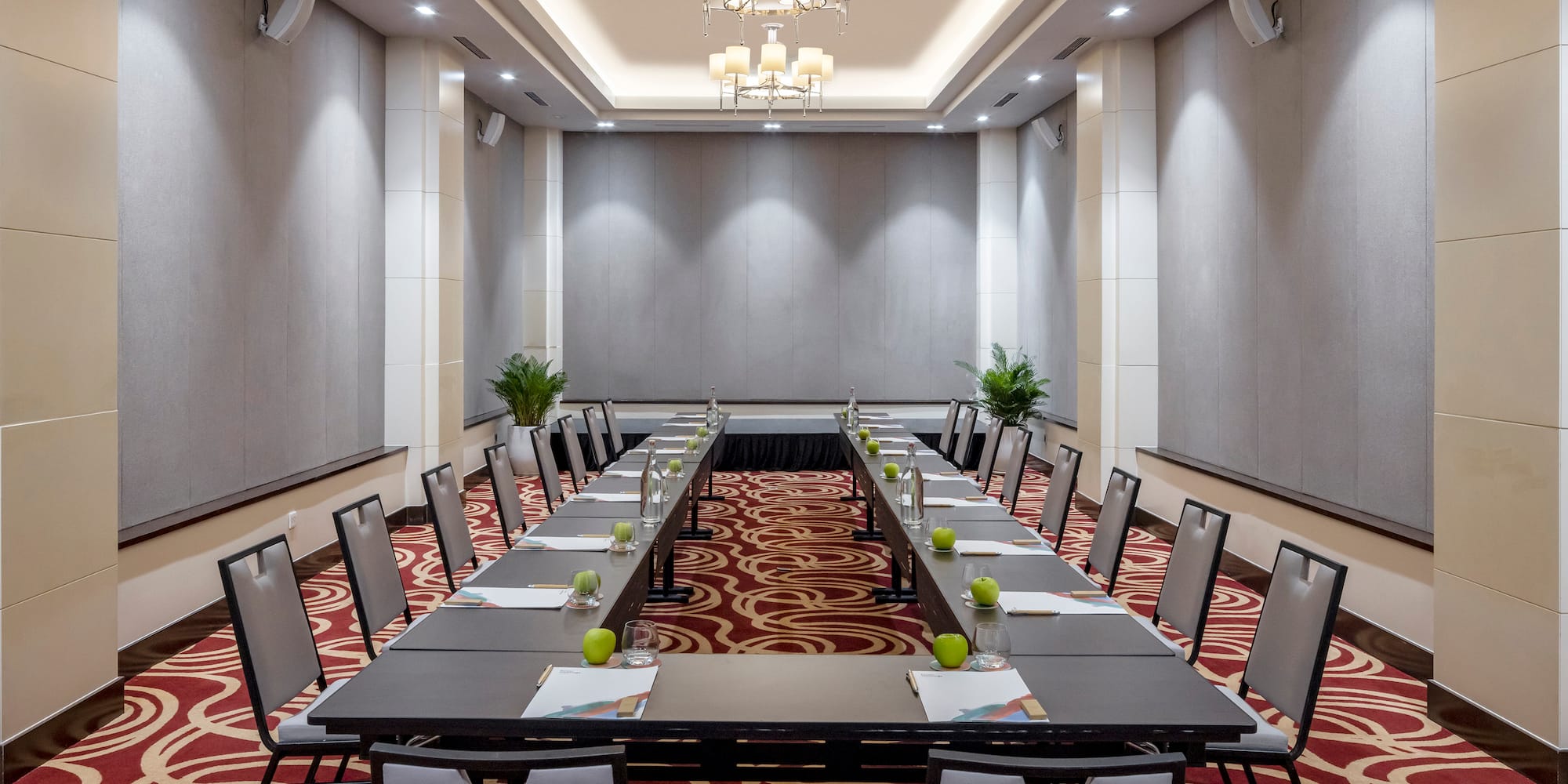 a room with long tables and chairs