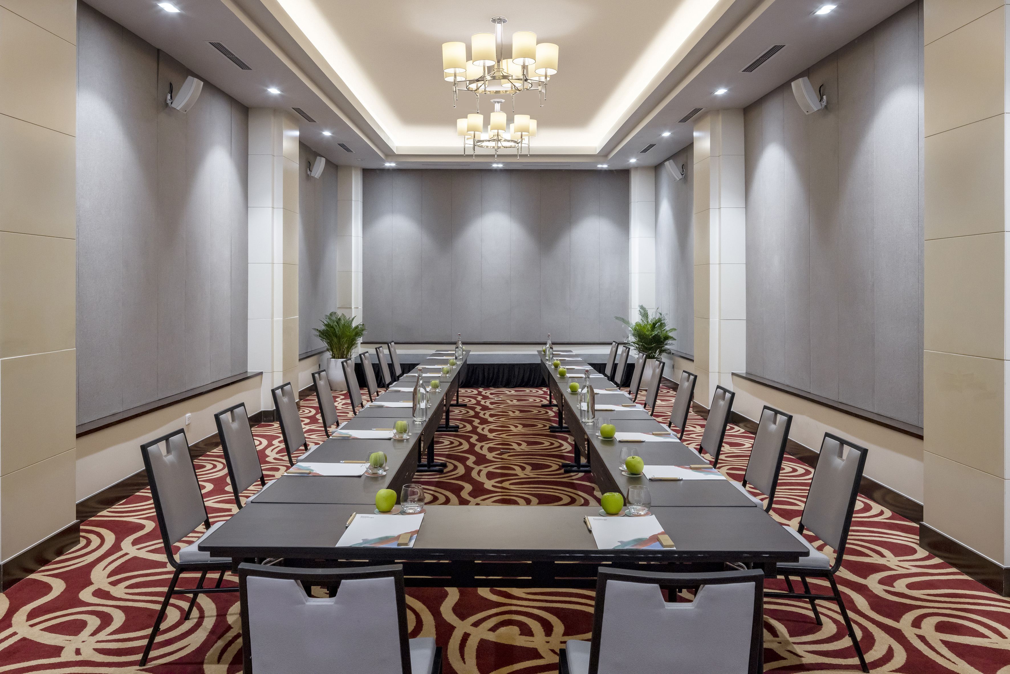 a room with long tables and chairs