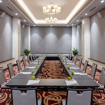 a room with long tables and chairs