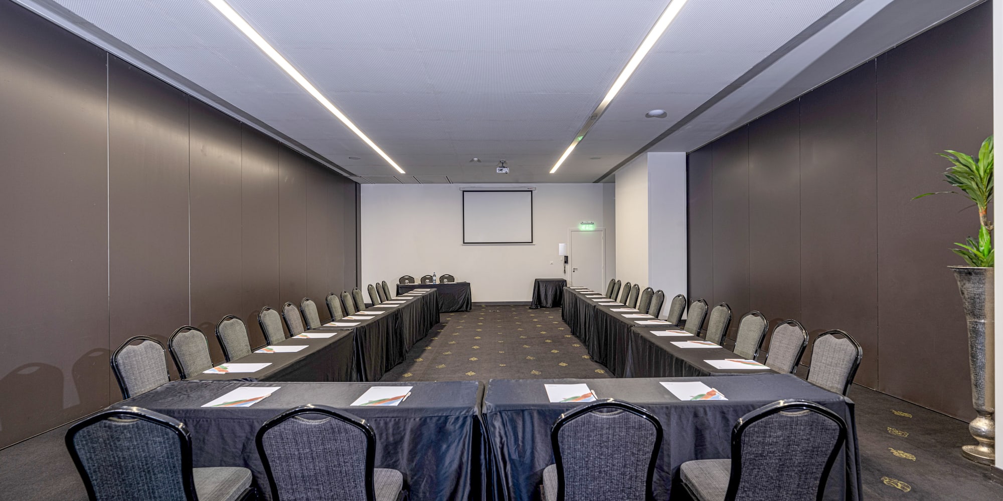 a room with a long table and chairs